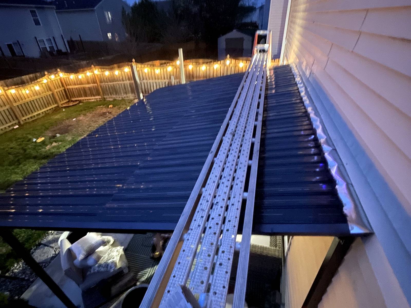 New gutter run installed along the roof edge and siding of a home