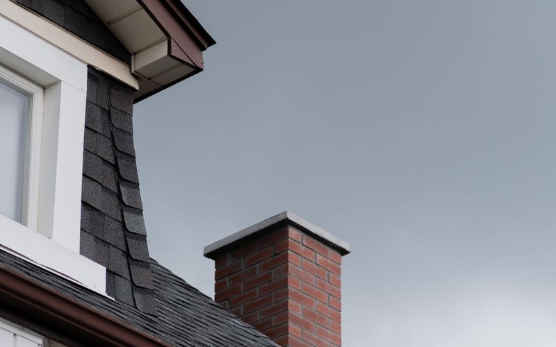 Roofline with gutters, fascia, and chimney
